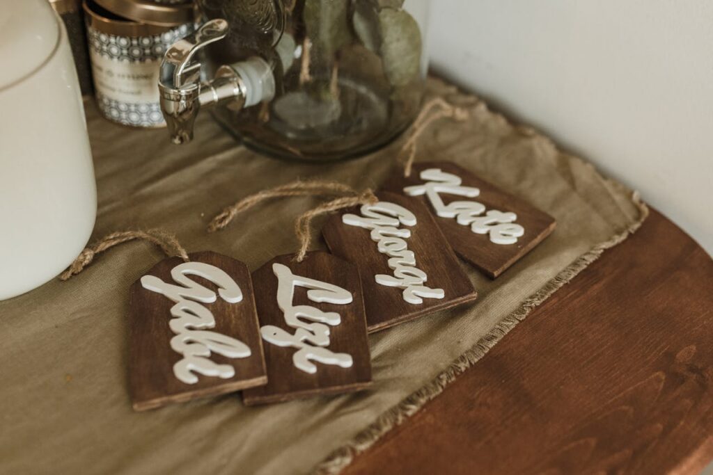 Charming wooden name tags with elegant script on a rustic tabletop setting.